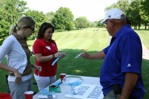 Simmons Hanly Conroy Attorney Sarah Burns and Alton School District Teacher Natalie Lewis sell 50/50 tickets during the 9th Annual SEF golf tournament.