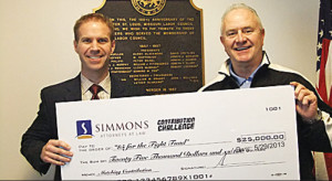 Attorney Chris Guinn presents a representative check to Union Leader Bob Soutier to represent the firm's pledge to match up to $25,000 of donations made to the "$5 for the Fight" Campaign.