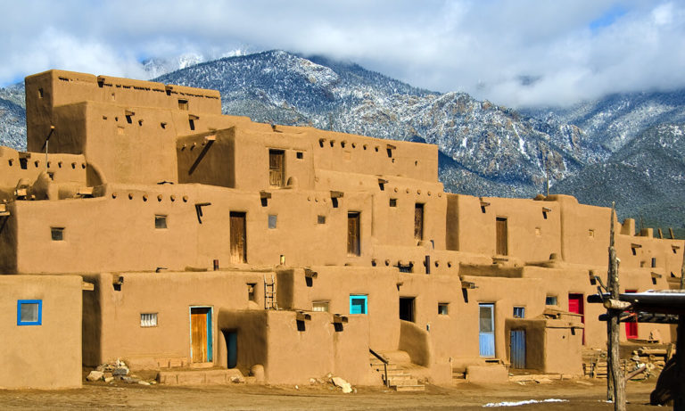 Brown buildings before mountains in Oregon