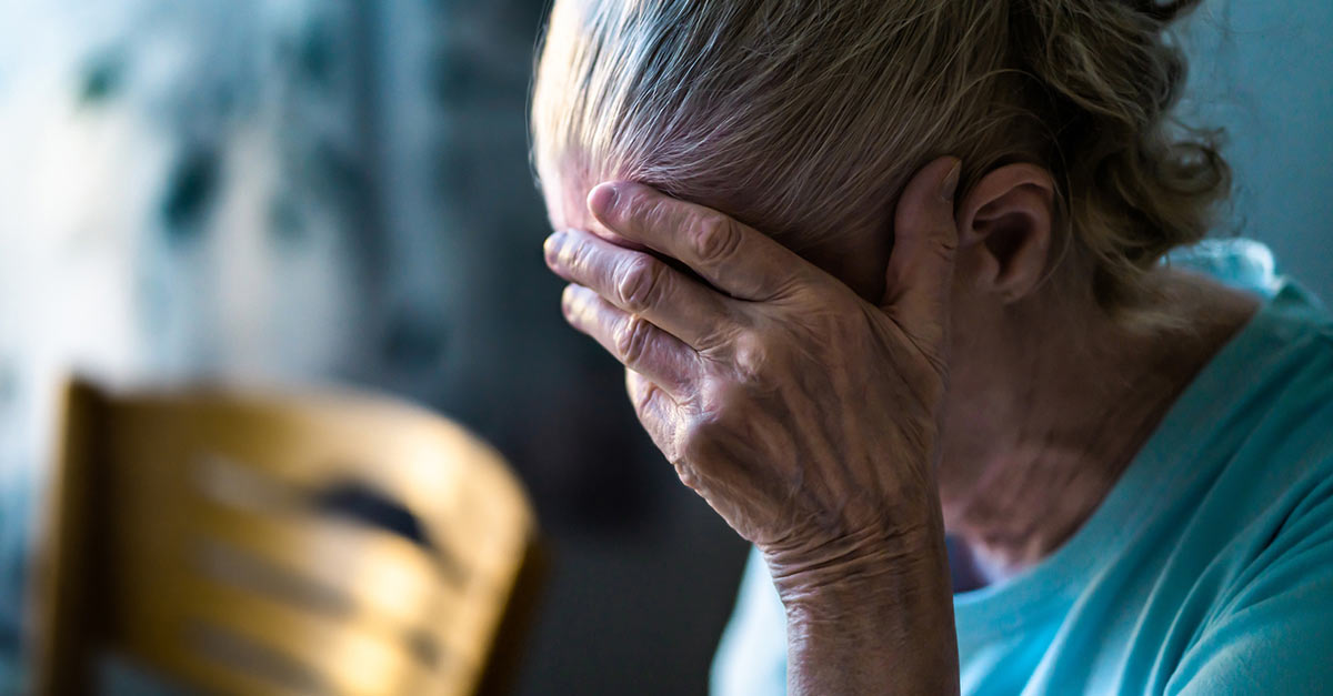 woman rests hand on face