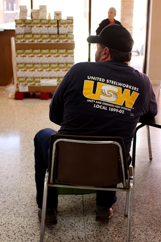 A laid-off steelworker waits for the event to begin. 