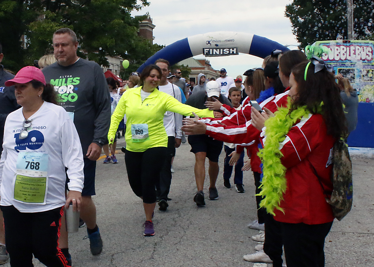 runners giving high fives at race