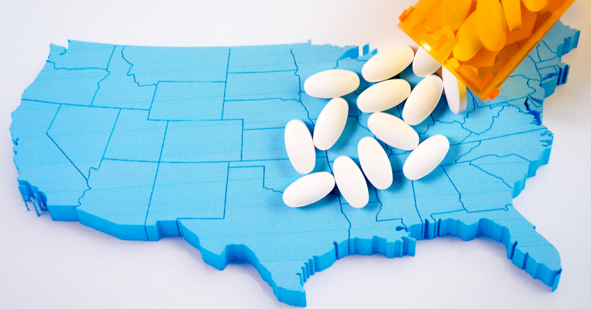 white prescription pharmaceutical pills on map