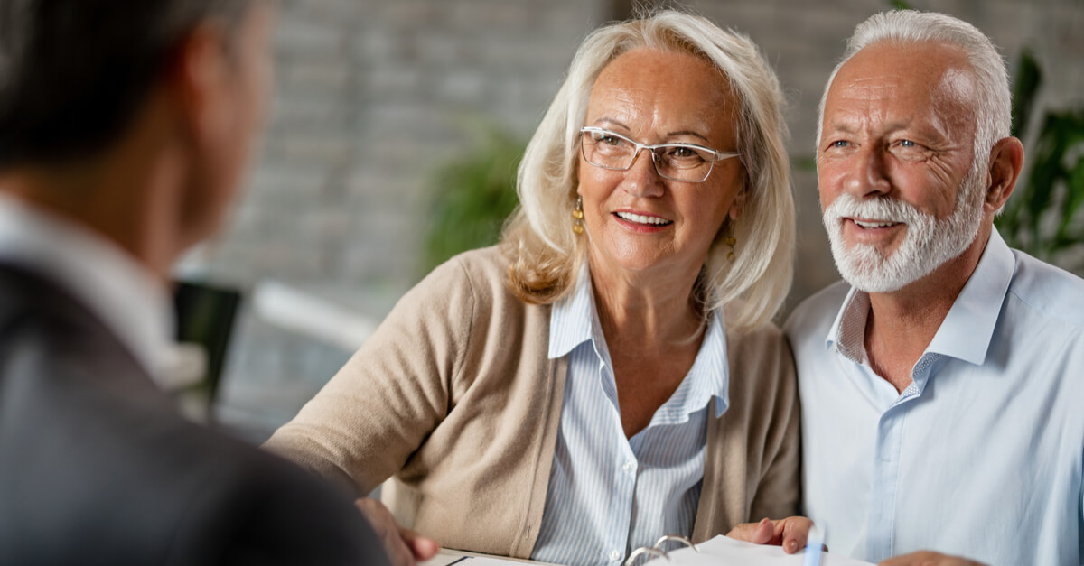two older adults speak with a lawyer