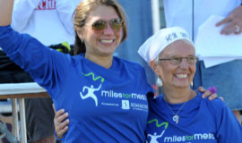 Julie and her mom triumphantly standing and hugging each other after finishing a race for mesothelioma