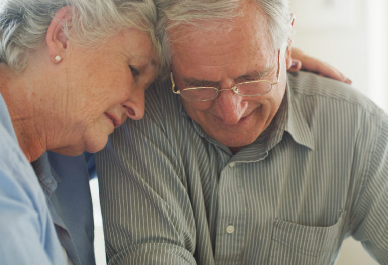 elderly couple hugging