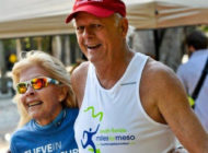 Larry davis happily crossing the finish line at miles for meso race