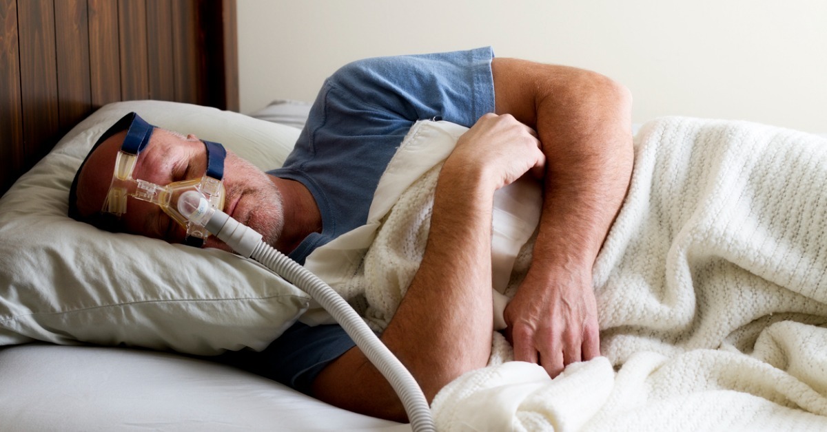 Man sleeping with CPAP Mask