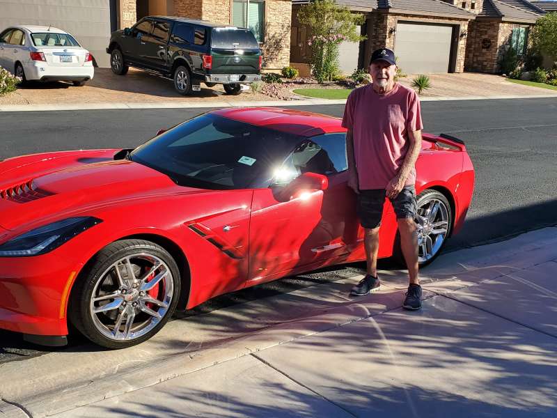 John Stahl next to his corvette