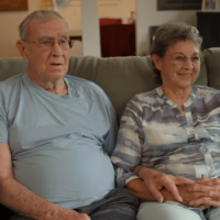 Art and his wife sitting on a couch