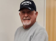 Photo of John Stahl, wearing a black baseball hat and gray sweatshirt
