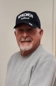 Photo of John Stahl, wearing a black baseball hat and gray sweatshirt