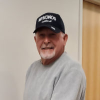 Photo of John Stahl, wearing a black baseball hat and gray sweatshirt