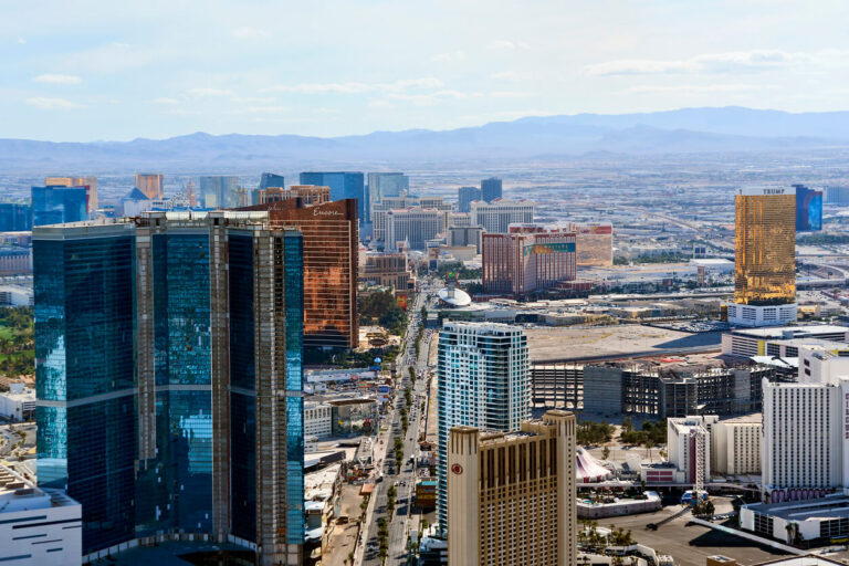 Las Vegas, NV — city buildings in the foreground of the picture with mountains visible in the distance