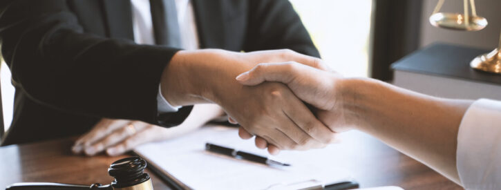 A lawyer shakes a client's hand