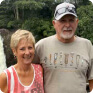John Stahl and his wife pose in front of a waterfall