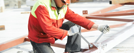 Man in a hard hat using tools at work