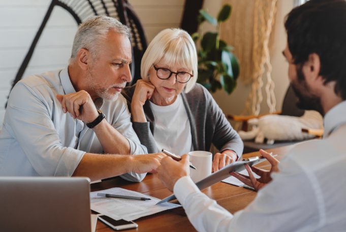 A couple reviews paperwork with an attorney