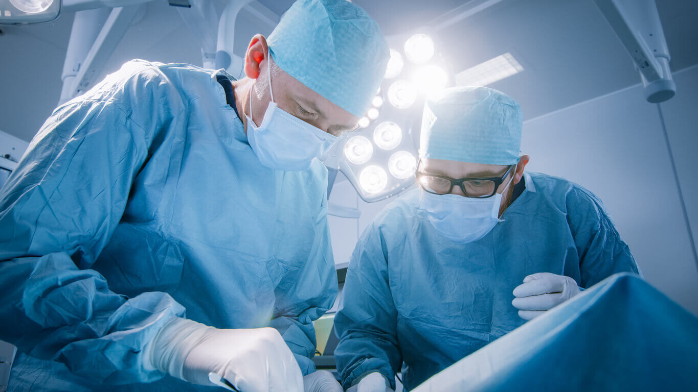 Two doctors perform surgery