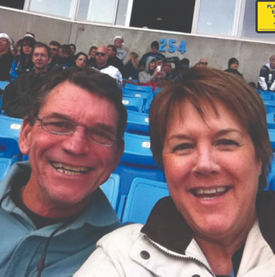 Norris, mesothelioma warrior, at a game with his wife