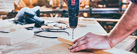 carpenter drilling into wood