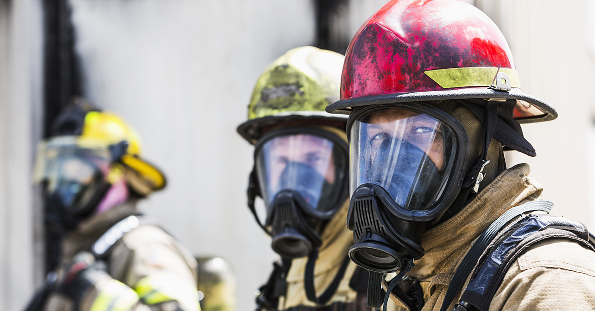 Three firefighters wearing protective gear