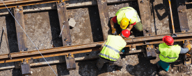 Railroad workers in neon yellow vests