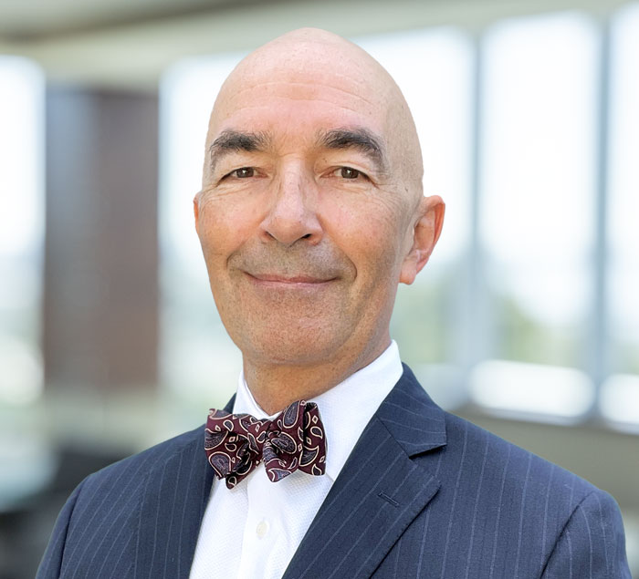 Attorney Juan Bauta in the office with a tie
