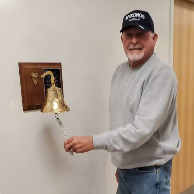 John, a mesothelioma survivor ringing a bell at the hospital
